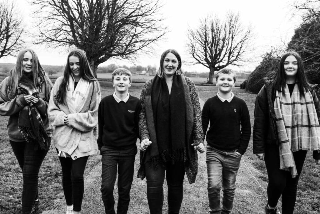 Families portfolio - a group of children walking towards the camera, image in black and white - Wrest Park