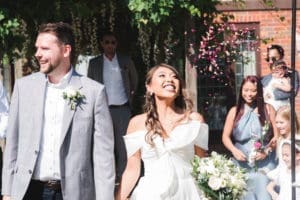 Wedding Photographer Bedfordshire Bride and Groom leaving the ceremony smiling