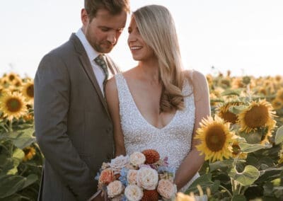 wedding photographer in Bedfordshire - bride and groom close up in a sunflower field